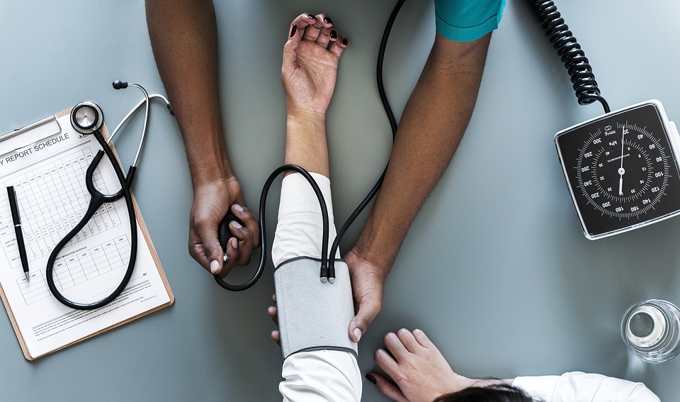 A doctor taking a patient's blood pressure